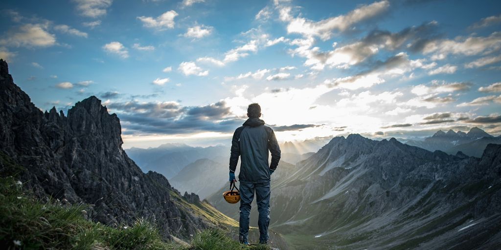 Urlaub in den Alpen mit Gletscherwanderung und Bergseen: Natur erleben - a man standing on top of a lush green hillside