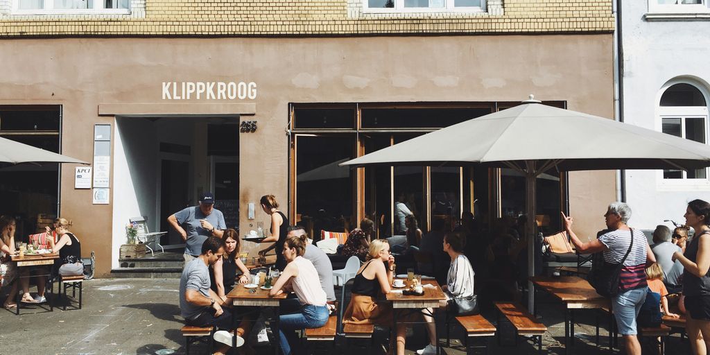 Urlaubstipps Deutschland mit Geheimtipps und Insiderwissen - group of people sitting on benches with tables beside Klippkroog store front at daytime